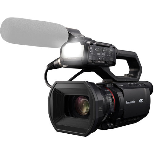 Front-side view of the Panasonic HC-X2000 UHD Camcorder, with a light and shotgun microphone, for use in event videography.