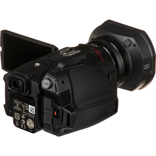 Rear-right angled view of the Panasonic HC-X2000 4K camcorder with LCD screen extended, ideal for