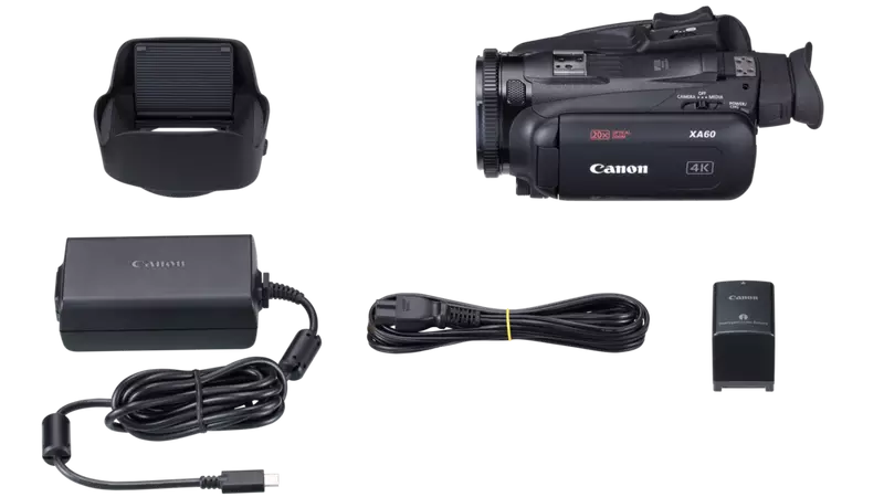 Top-down view of a Canon XA60 camera bundle, featuring camcorder body, lens hood, power supply, remote, and battery unit.